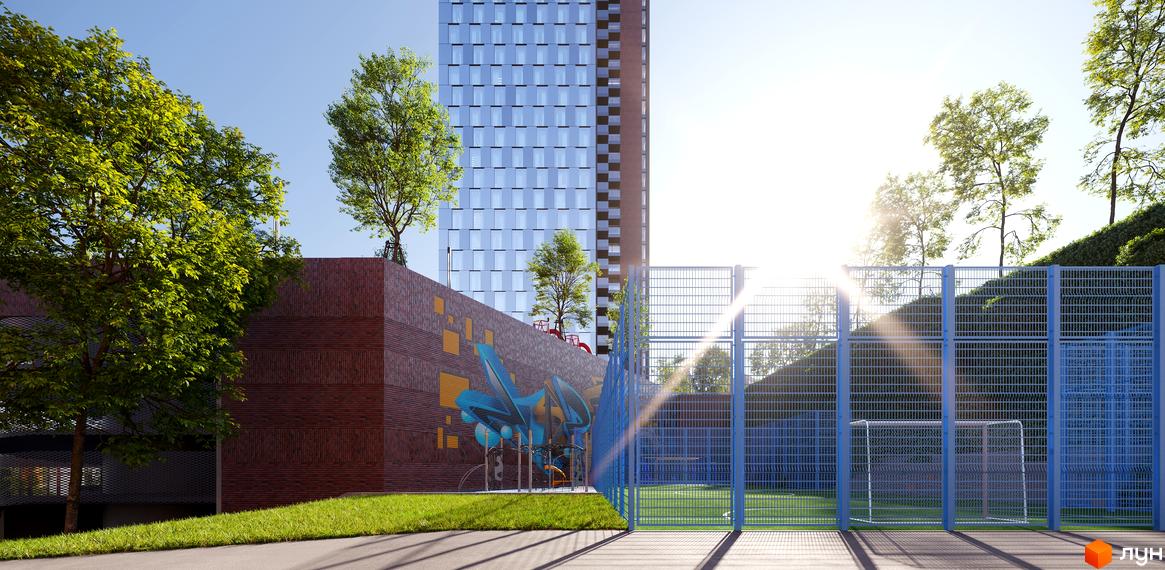 БФК MAYAK: багатоповерховий будинок зі скляним фасадом та спортивним майданчиком з синім огородженням.