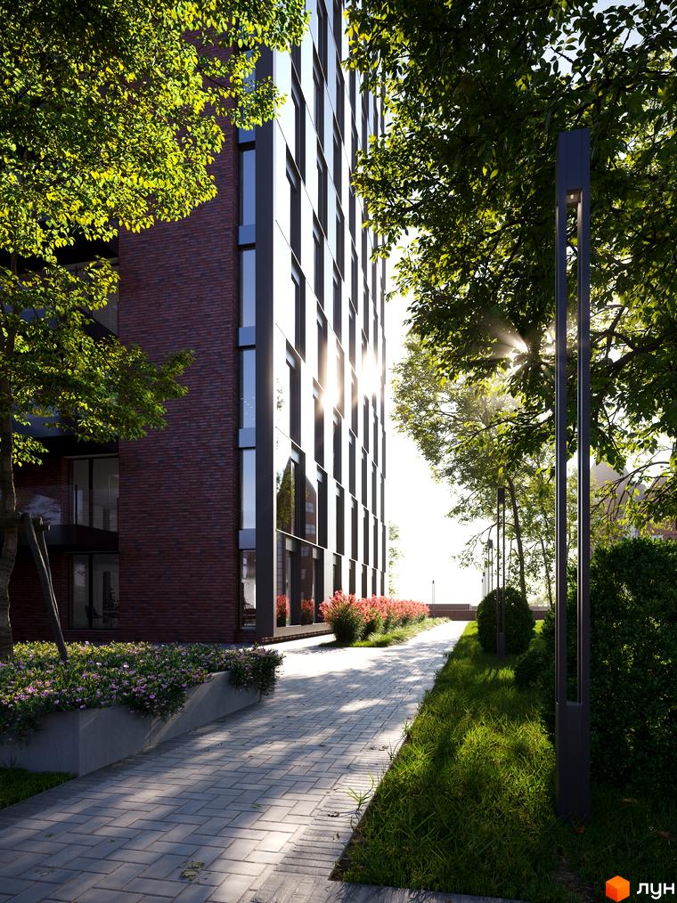 БФК MAYAK: фасад будівлі з цегли та скла, зелена прибудинкова територія з доріжками та освітленням.