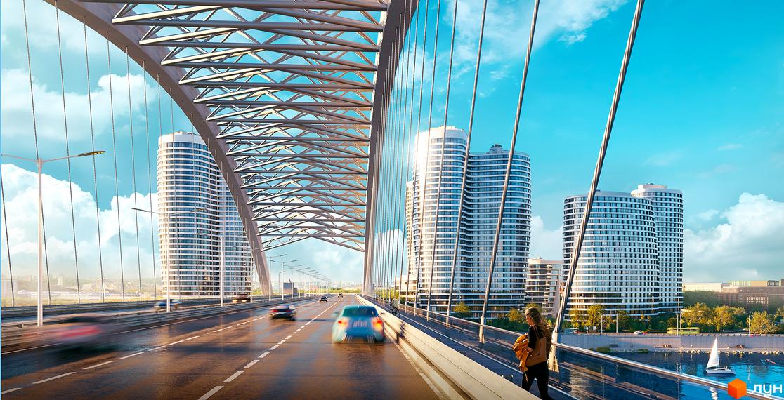 Житловий комплекс OASIS з високими багатоповерховими будинками на березі річки. На передньому плані видно міст з автомобілями та пішохідною зоною.