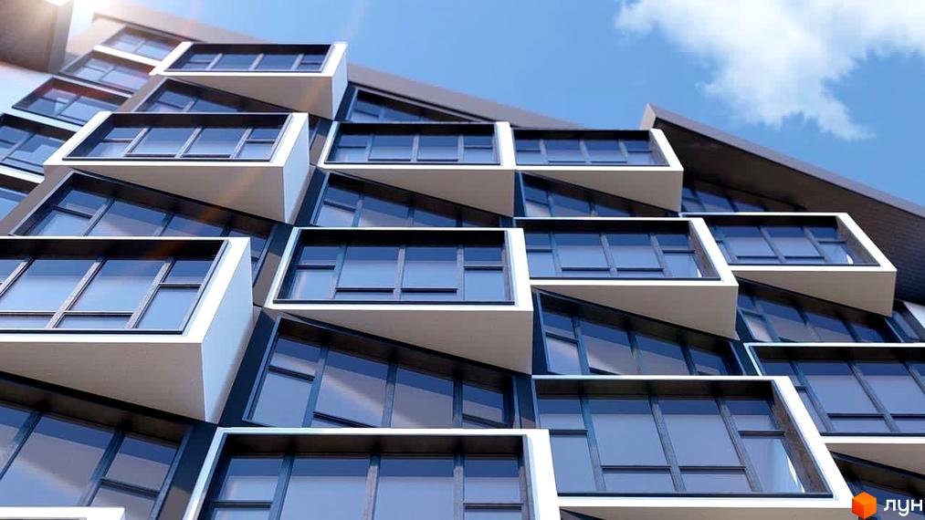 Зображення фасаду Житлового комплексу Argo з великими вікнами та балконами. Архітектура будинку з чіткими лініями на фоні блакитного неба.