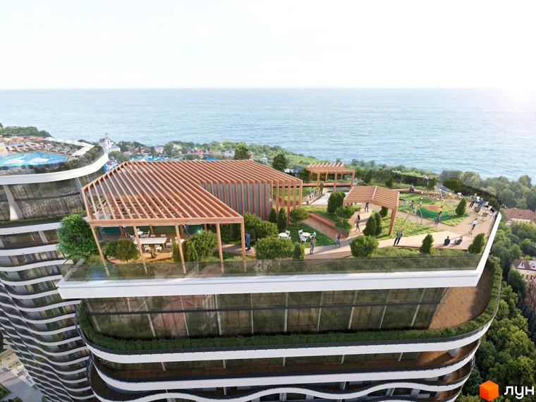 Житловий комплекс Unity Towers з хвилястими фасадами та великим зеленим дахом, де розташовані дитячий майданчик, зони відпочинку та кафе з видом на море.