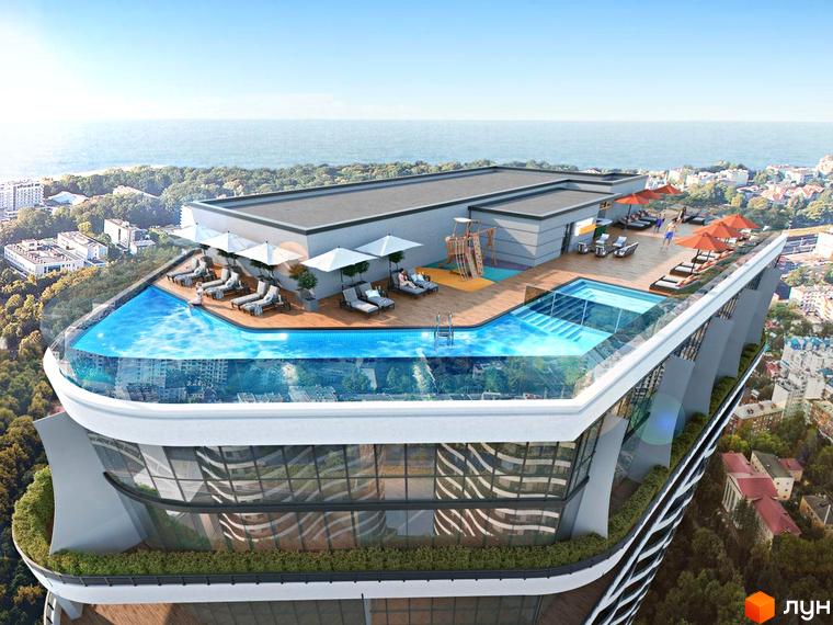 Будівля Unity Towers з вигнутими фасадами та панорамними вікнами. На даху розташований басейн з прозорими стінами, зона відпочинку та вид на море.