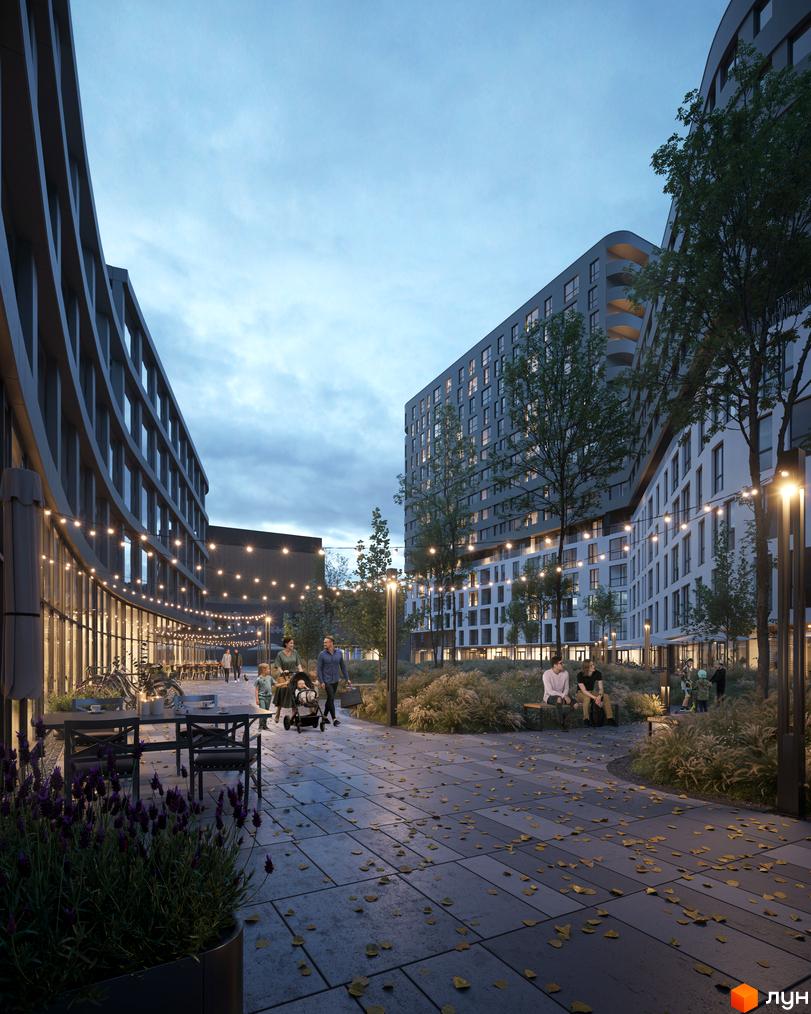 Сучасний житловий комплекс Safe Town з вигнутими фасадами та освітленим внутрішнім двором. Прибудинкова територія з лавочками, деревами та освітленням.