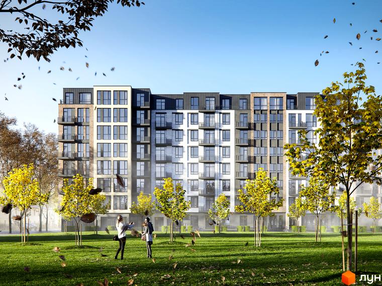 Комплекс Avalon Yard з цегляним та білим фасадами, балконами та великими вікнами, оточений деревами з жовтим листям та зеленим газоном.