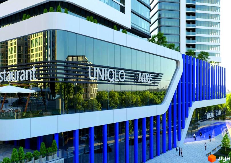 Зовнішній вигляд новобудови ЖК Aura city з фасадами з скла та синіми елементами. На першому поверсі розташовані магазини UNIQLO та NIKE. Прибудинкова територія з висадженими деревами та пішохідною зоною.