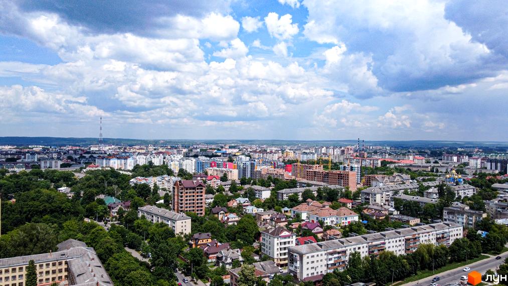 Вид на житловий комплекс Парковий маєток з висоти пташиного польоту. Комплекс складається з багатоповерхових будинків, оточених зеленню та міською забудовою.