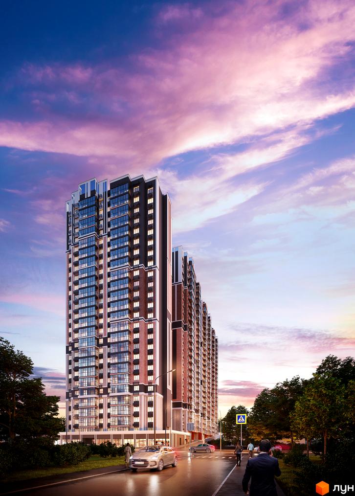 Житловий комплекс Голосіївський з фасадами з цегли та панорамними вікнами на тлі вечірнього неба. Поруч дорога з автомобілями та зелені насадження.