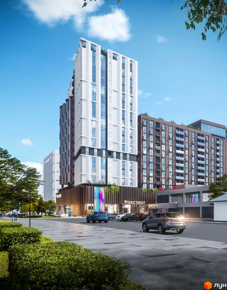 Висока будівля Комплексу Capital Tower зі світлим фасадом та великими вікнами. Навколо — доріжки, зелені насадження та автомобілі.