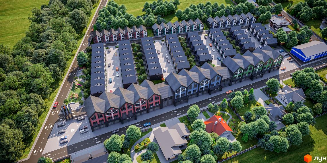 Вид зверху на Таунхауси Freya з різнокольоровими фасадами та сірими дахами, оточені зеленими деревами, дорогами та дитячим майданчиком.