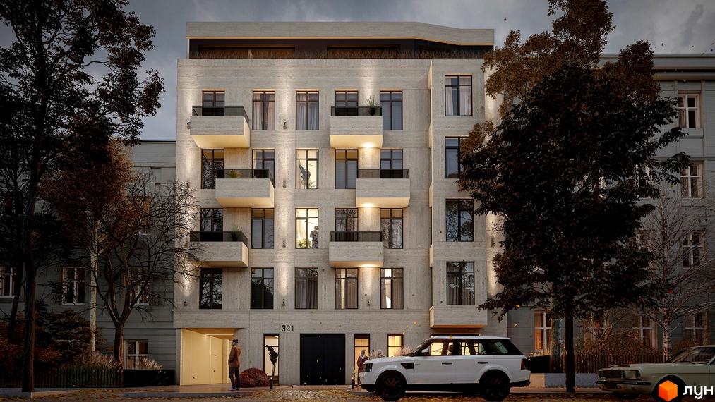 Фасад будинку по вул. Коновальця, 21, з балконами та вікнами, освітлений ввечері. Перед будинком прибудинкова територія з деревами та автомобілями.