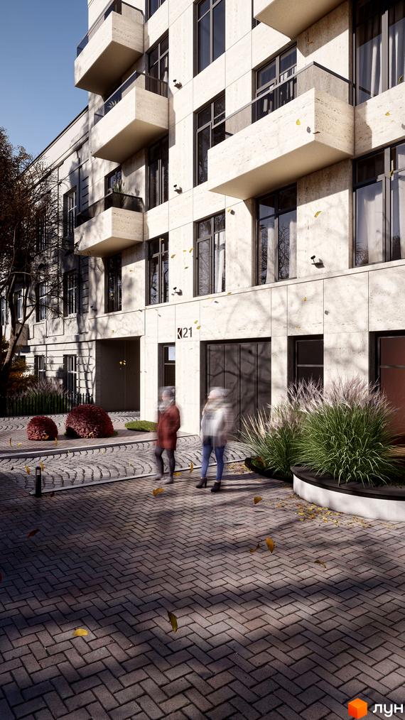 Житловий комплекс на вул. Коновальця, 21 з фасадом світлого кольору, балконами та великими вікнами. Прибудинкова територія з бруківкою та зеленими насадженнями.