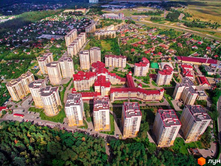 Аерофото Житлового комплексу Чайка. Видно багатоповерхові будинки зі світлими фасадами та червоними дахами, оточені великою кількістю зелених зон та доріг.