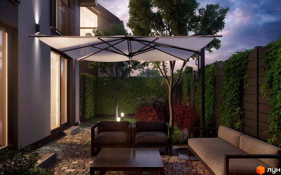 Фасад будинку Котеджного містечка KyivOasis з великими вікнами. На прибудинковій території облаштована тераса з патіо, вуличними меблями та зеленими насадженнями.