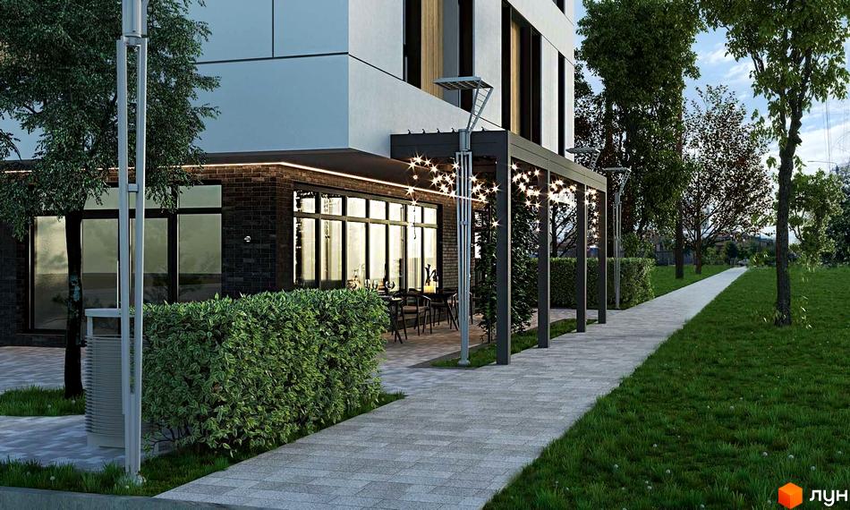 Фасад Клубного будинку на Центральній з темної цегли та великими вікнами. Поруч розташована вимощена доріжка, зелені газони та зона відпочинку з освітленням.