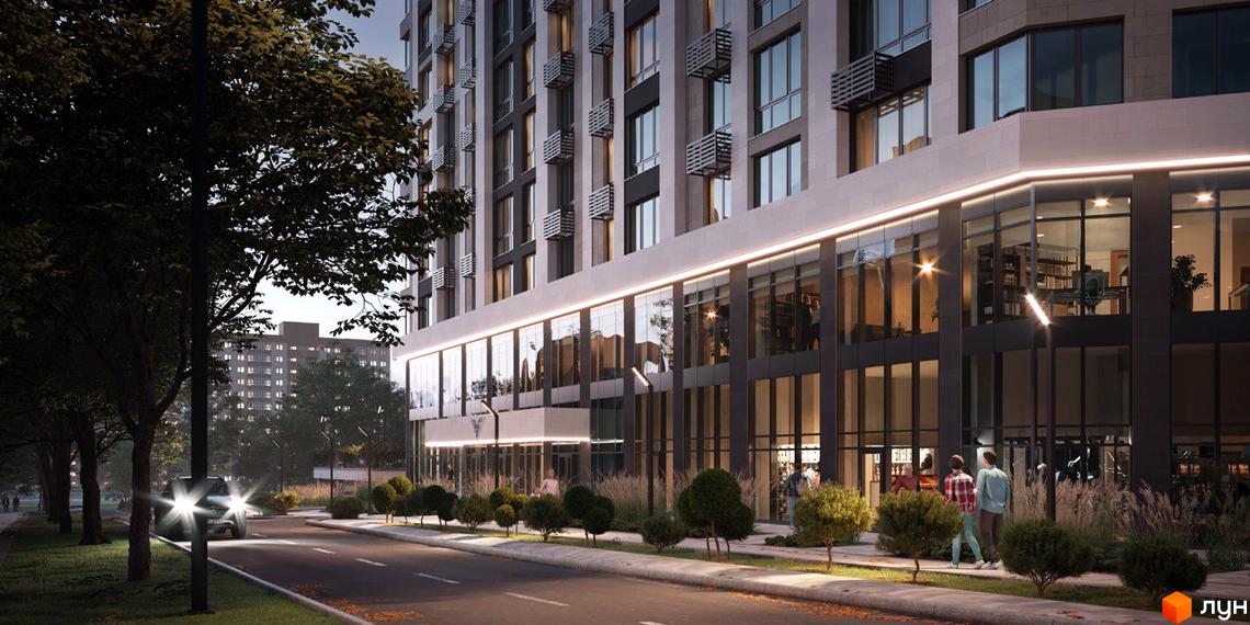 Новобудова ЖК Liberty Gardens з великими вікнами та підсвіткою фасаду. Поряд розташована доглянута прибудинкова територія з деревами та кущами.