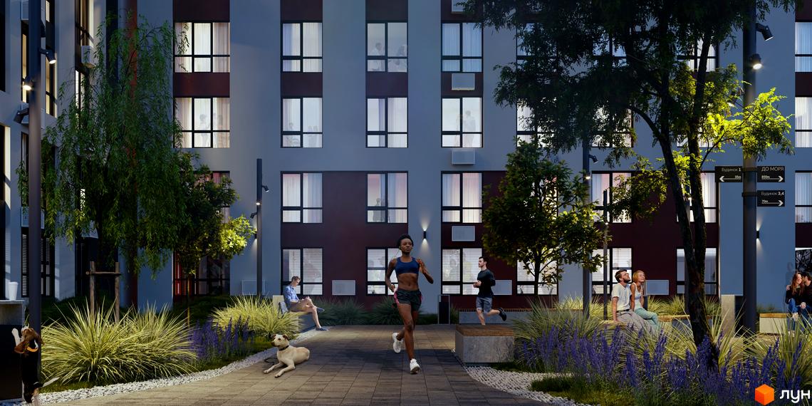 Житловий комплекс Sea View з фасадами сірого та бордового кольорів. На прибудинковій території розташовані зелені насадження, лавки та люди, що відпочивають.