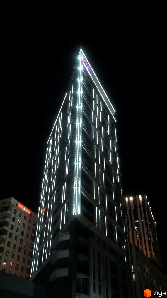 Житловий комплекс Щасливий Platinum вночі з підсвіткою. Зовнішній вигляд будівлі з численними вертикальними лініями світла.