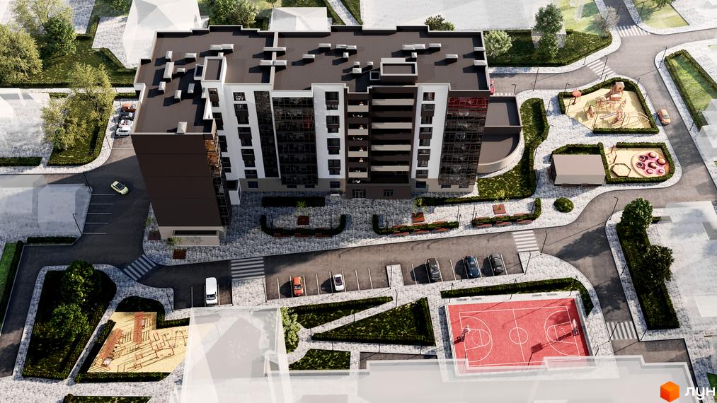 Вид на житловий комплекс Центральний з висоти пташиного польоту, що демонструє сучасну архітектуру будівлі та облаштовану прибудинкову територію з дитячими майданчиками та спортивними зонами.