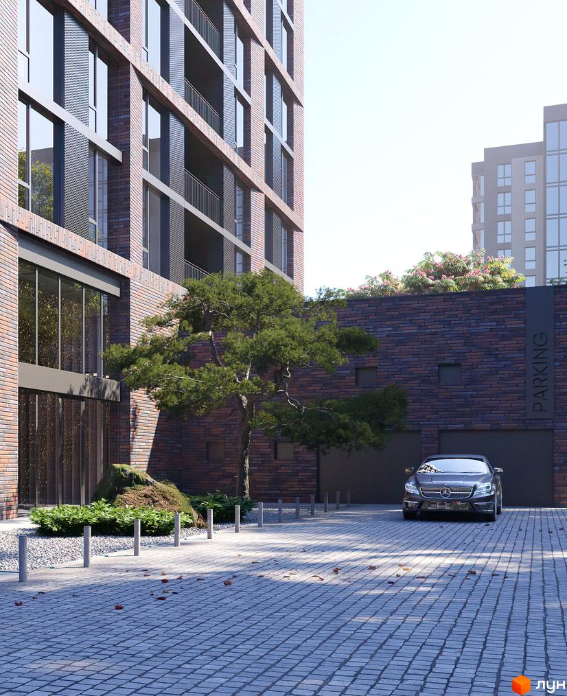 Зовнішній вигляд будівлі ЖК MARSHALL з цегляними фасадами та паркуванням. На території є дерева, бруківка та автомобіль.