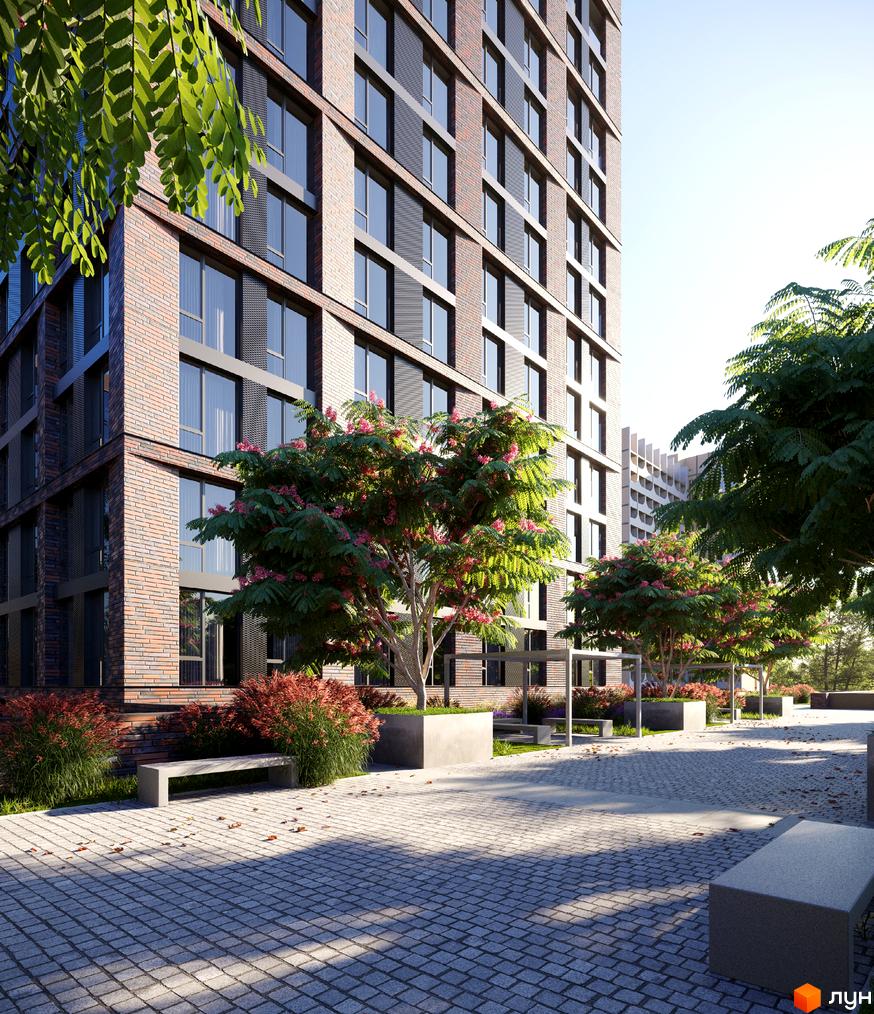 Будинок ЖК MARSHALL з цегляним фасадом та великими вікнами, оточений зеленню та вимощеною бруківкою зоною відпочинку з лавками.