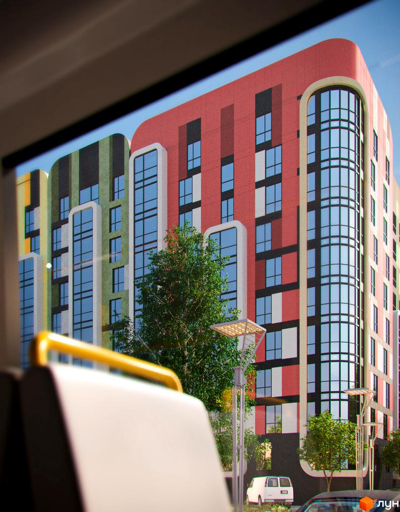 Зображення фасаду та вікон Житлового комплексу Karat. На передньому плані видно частину салону автобуса.