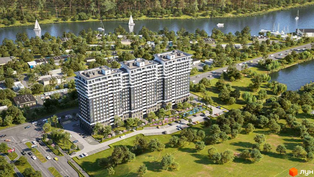 Високоповерховий будинок ЖК River Plaza біля річки з великою прибудинковою територією та парковкою. Навколо багато зелені та дерев.