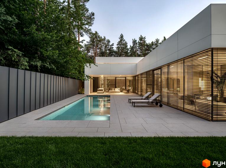 Вигляд будинку з басейном у Котеджному містечку 3L Residences. Навколо зелений газон та дерева.