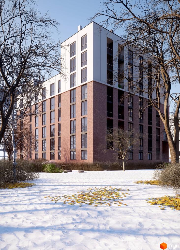 Зображення фасаду цегляного будинку в Житловому районі New з великими вікнами. Навколо сніг та дерева без листя.