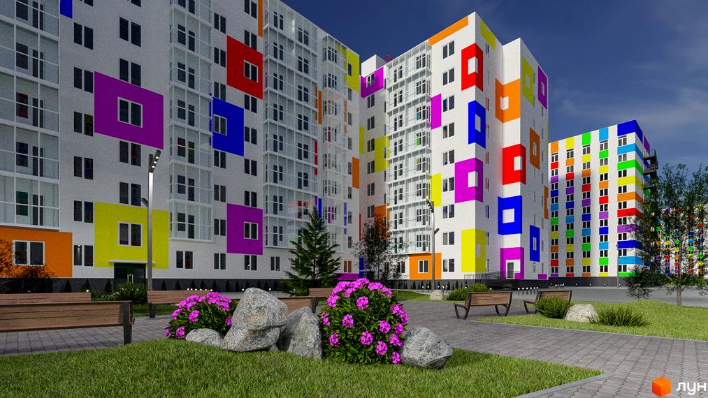 Яскравий житловий комплекс з кольоровими фасадами. На території комплексу є лавки, зелені насадження та доріжки з бруківки.