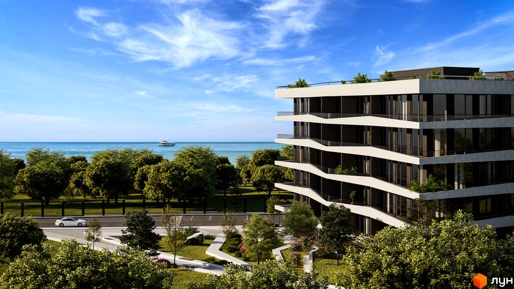 Зображення апарт-комплексу Primorsky Residence з виглядом на море. На передньому плані зелена територія та будівля.