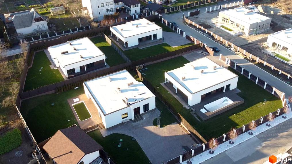 Котеджне містечко КМ White Stone. Сучасні білі будинки з плоскими дахами та доглянутою зеленою територією з басейном.