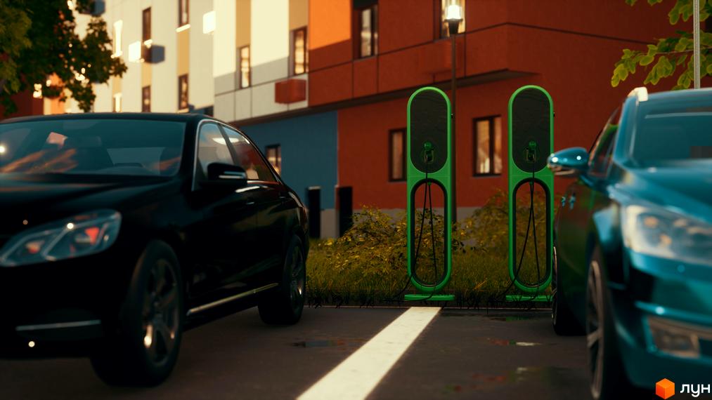 Зображення житлового комплексу Smart з зарядними станціями для електромобілів. На передньому плані автомобілі.