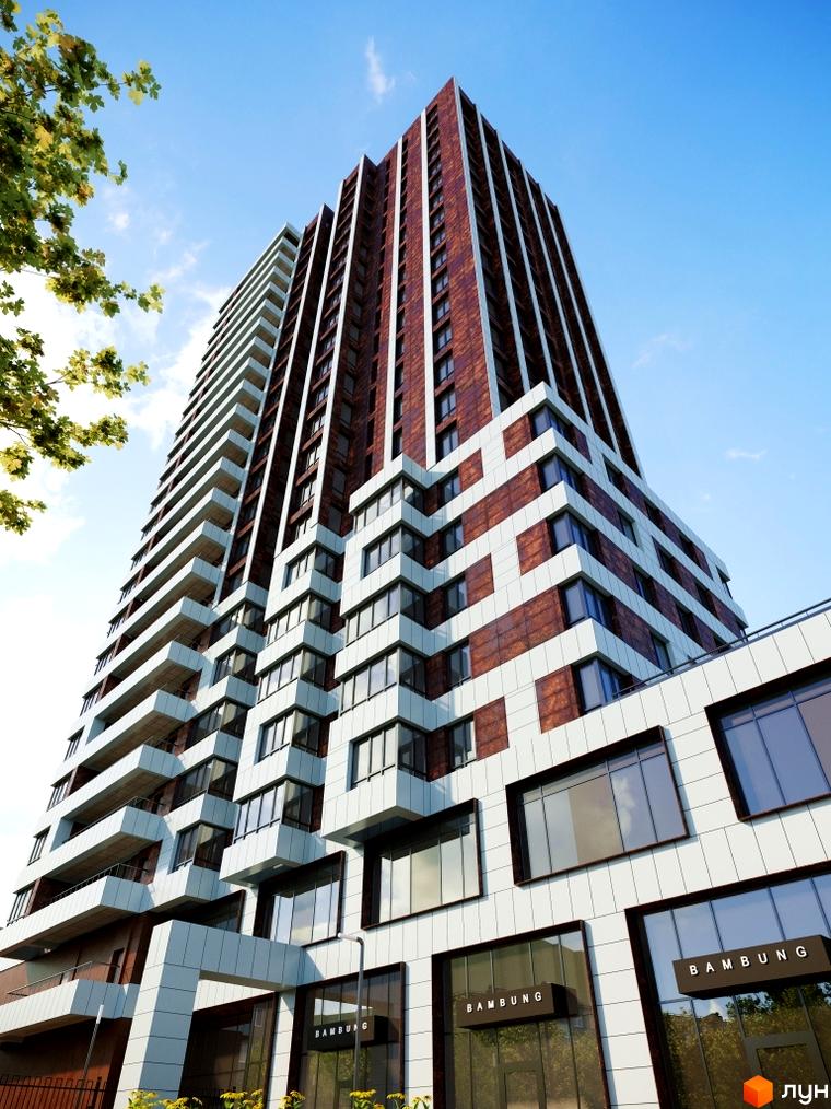 Зовнішній вигляд житлового комплексу Космос: висотна будівля з балконами та панорамними вікнами. На першому поверсі розташовані комерційні приміщення з вивісками.