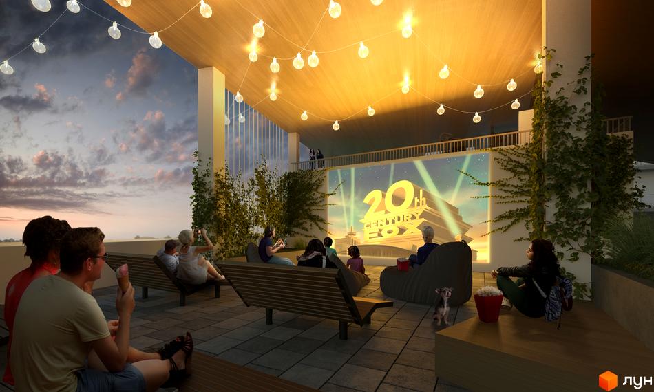 Простора тераса Житлового містечка ARTVILLE з відкритим кінотеатром, освітлена гірляндами, для вечірнього відпочинку.