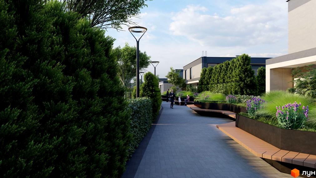 Котеджне містечко Ariel Village з доглянутою прибудинковою територією, доріжками та зонами відпочинку. Сучасні будинки та зелені насадження створюють затишну атмосферу.