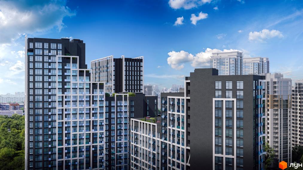 Зовнішній вигляд житлового комплексу Nordica Residence з багатоповерховими будинками різних форм та кольорів на тлі блакитного неба з хмарами. Навколо зелені дерева.