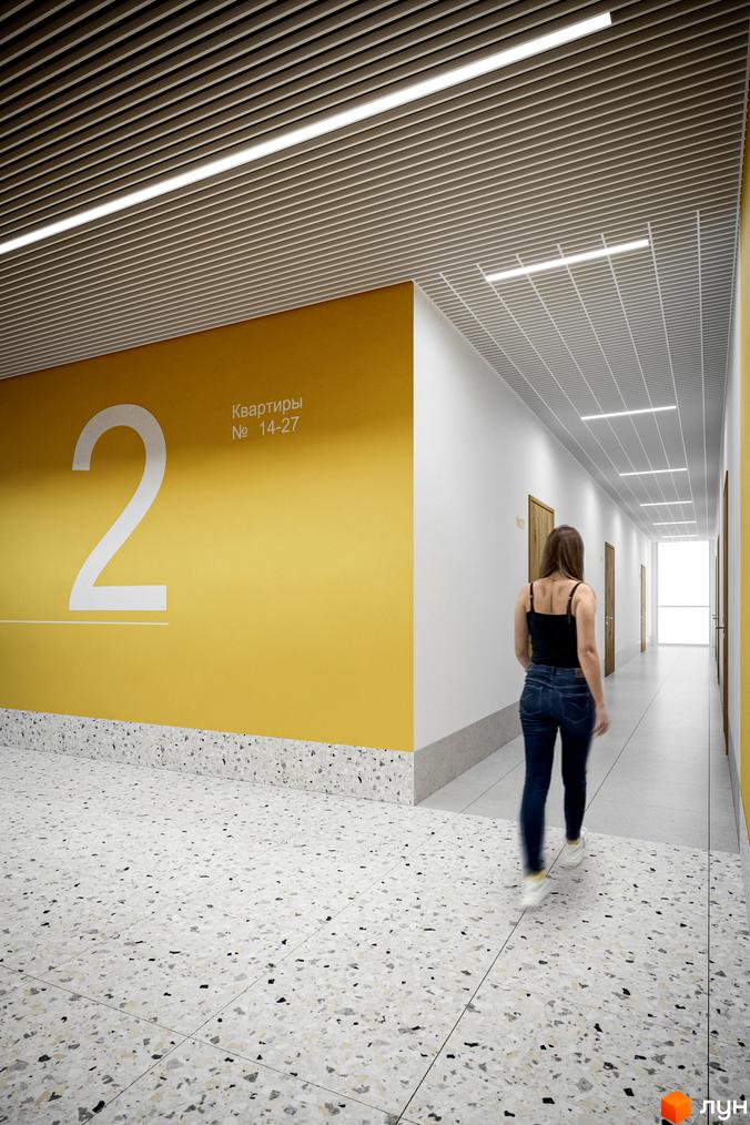 Холл Житлового комплексу Мармелад з жовтою стіною, світлою підлогою та стелею з вбудованим лінійним освітленням.