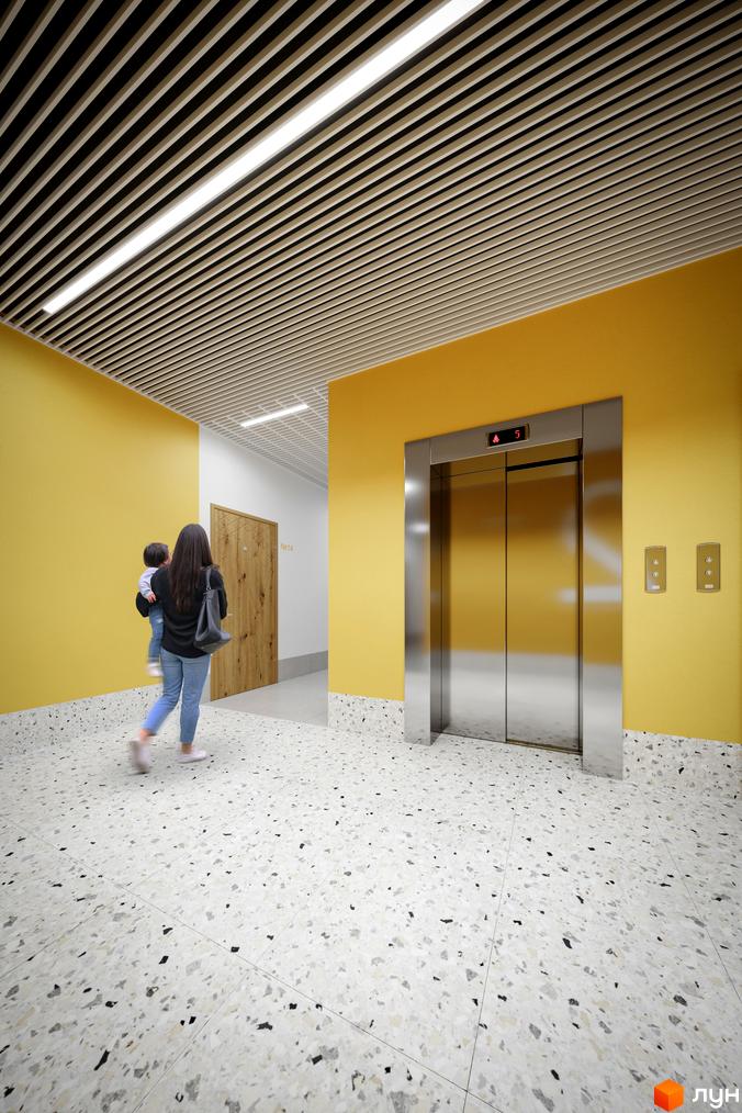 Сучасний інтер'єр холу житлового комплексу Мармелад з ліфтом та дверима. Підлогове покриття з terrazzo та жовті стіни створюють яскравий простір.
