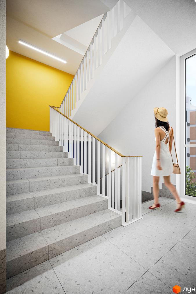 Світлий під'їзд з жовтою стіною та сходами в ЖК Мармелад. Житловий комплекс Мармелад пропонує комфортне проживання.