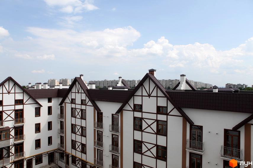 Зовнішній вигляд житлового комплексу На Холодній горі з характерними архітектурними елементами. Прибудинкова територія з облаштованими балконами.