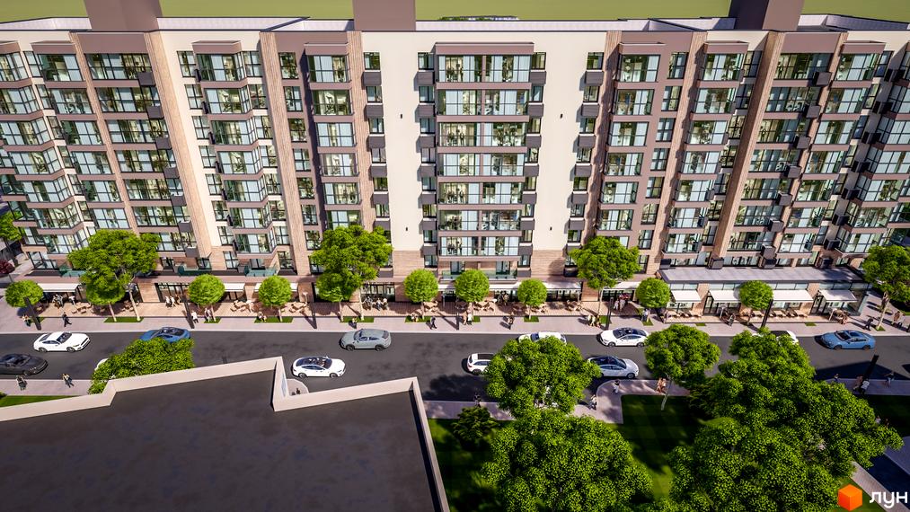 Високий будинок ЖК PARKOVIY з великими вікнами та балконами. Перед будинком розташована дорога з припаркованими автомобілями та зелені насадження.