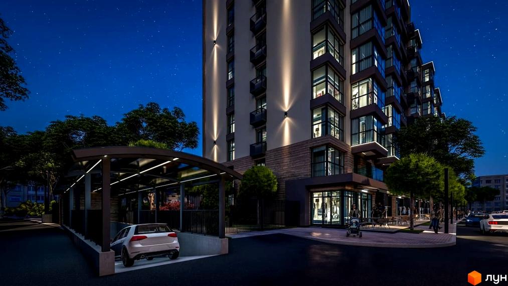 Висотна будівля Житловий комплекс PARKOVIY вночі з підсвічуванням фасадів. На території є парковка, алея з деревами та вхід до комерційних приміщень.