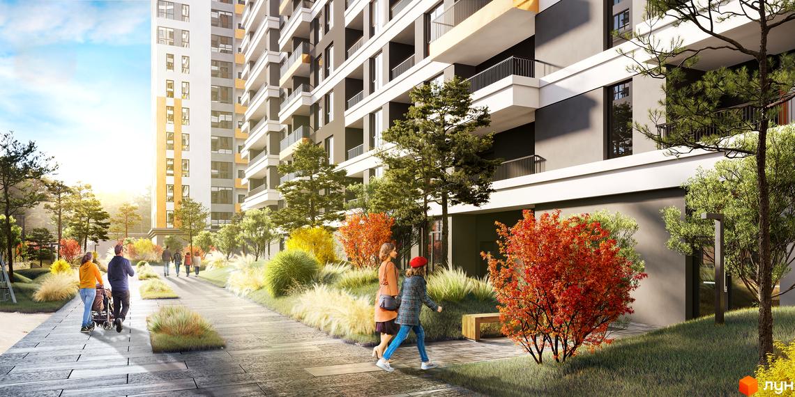 Житловий комплекс MAVERICK RESIDENTIAL COMPLEX з фасадом біло-жовтого кольору та прибудинковою територією з деревами та кущами.