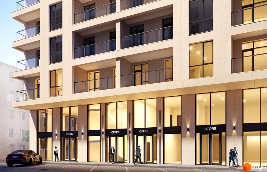 Житловий комплекс Жовтневий: багатоповерховий будинок зі світлим фасадом, великими вікнами та балконами. На першому поверсі магазини та офіси, поруч дорога.