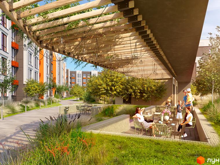 Житловий комплекс Найкращий квартал-2 з фасадами білого та помаранчевого кольорів та зоною відпочинку з альтанкою та зеленими насадженнями.