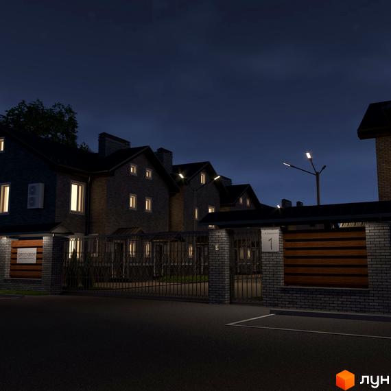 Котеджне містечко GREENBOR вночі. Фасади будинків з цегли, освітлені вікна, закрита територія з огорожею та вуличними ліхтарями.