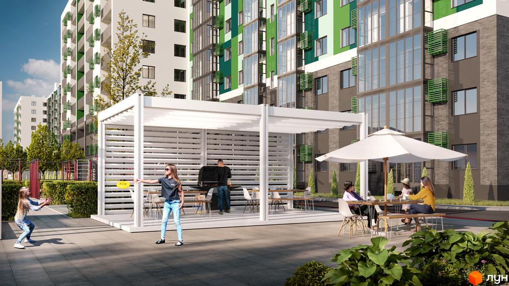 Житловий комплекс Гідропарк Сіті з фасадами у світлих тонах. На прибудинковій території облаштовані зони відпочинку з альтанками та столиками.