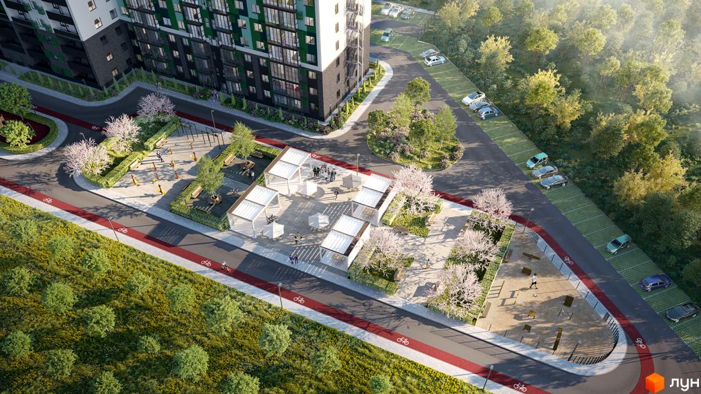 Висотна будівля ЖК Гідропарк Сіті з фасадом у світлих тонах. На прибудинковій території облаштовані зони відпочинку, дитячий майданчик та парковка.