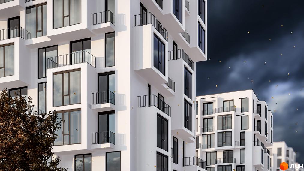 Житловий комплекс В4 з білими фасадами, великими вікнами та чорними балконами на тлі хмарного неба. Навколо будівлі видно дерева та золоте листя.