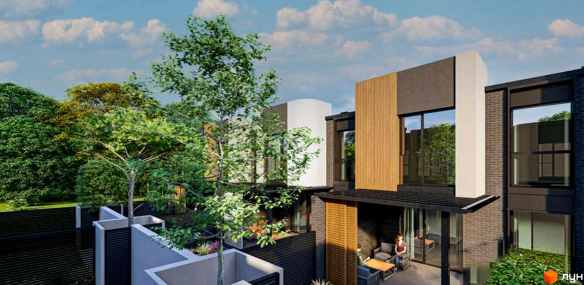 Котеджне містечко КМ ВДОМА з цегляним фасадом та дерев'яними елементами, що оточене зеленню та має затишну терасу з меблями.